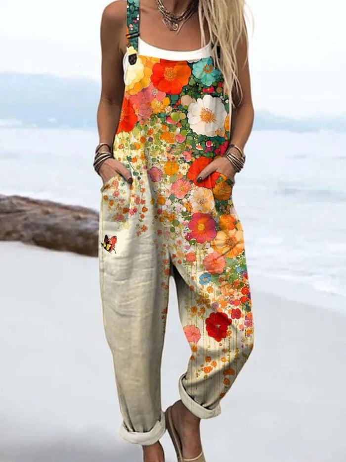 Woman wearing a multicolor vintage floral wide-leg jumpsuit with an adjustable waist tie, styled for a relaxed summer look