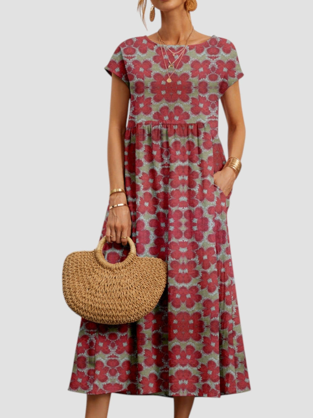 Woman wearing a flowy green vintage floral maxi dress in a bright outdoor setting