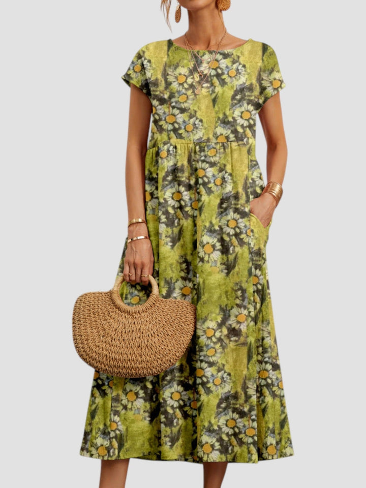 Close-up of the vintage floral print detail on a lightweight maxi dress in green