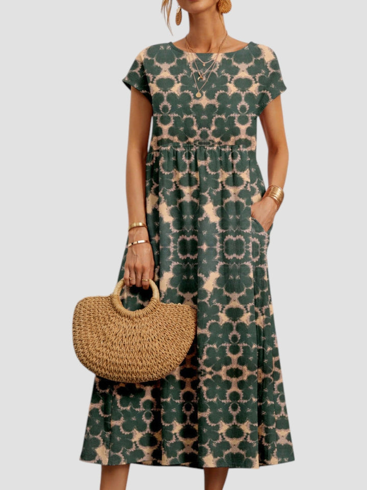 Model styled in a khaki vintage floral maxi dress paired with sandals for a casual summer look