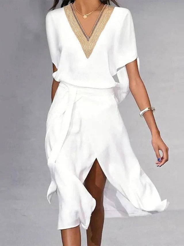 Women's white midi dress with gold V-neck trim, batwing short sleeves, and asymmetric wrap skirt, front view