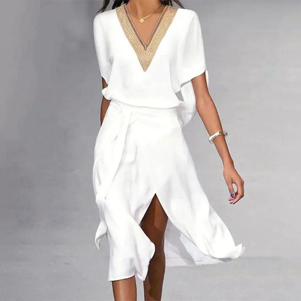 Side view of Florimay Lyra white midi dress showing flowing asymmetric hem and self-tie belted waist