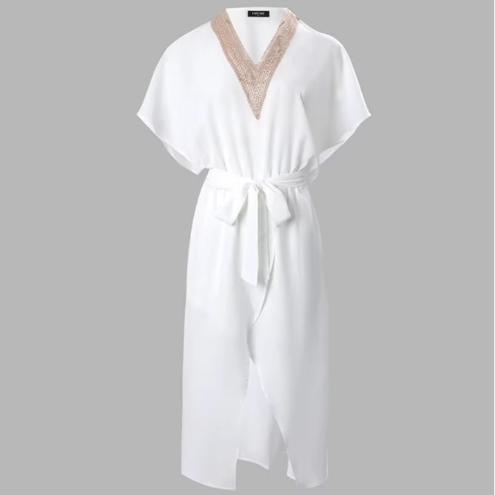 Close-up of intricate gold embellished V-neckline detail on white midi dress