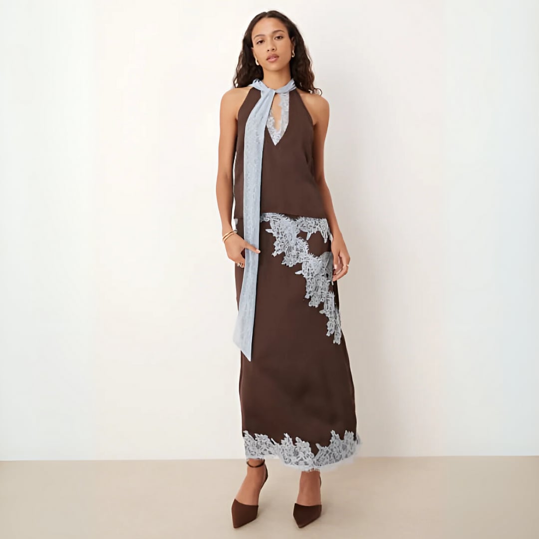 Front view of an elegant brown lace panel top and skirt set on a model, showing intricate lace detailing at the neckline