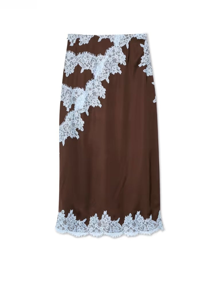 Model posing in the brown lace panel skirt set in a bright, airy setting
