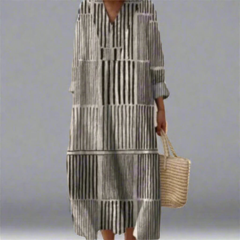Woman wearing an elegant geometric-print dress with a flowing silhouette in a modern, eye-catching pattern