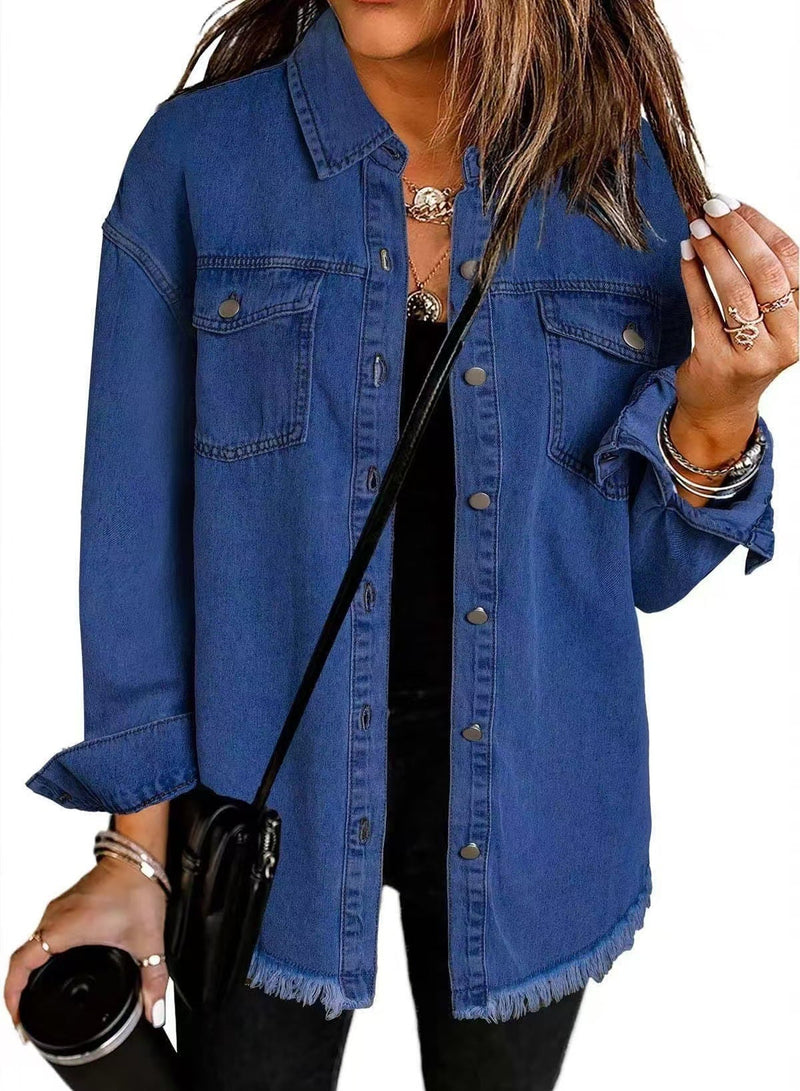 Side profile of woman in an oversized denim jacket layered over a simple outfit