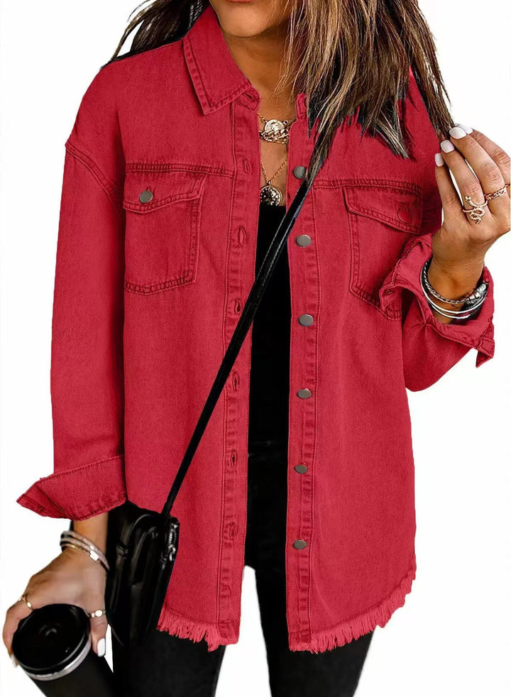 Woman smiling in a dark blue denim jacket styled as an everyday casual layer