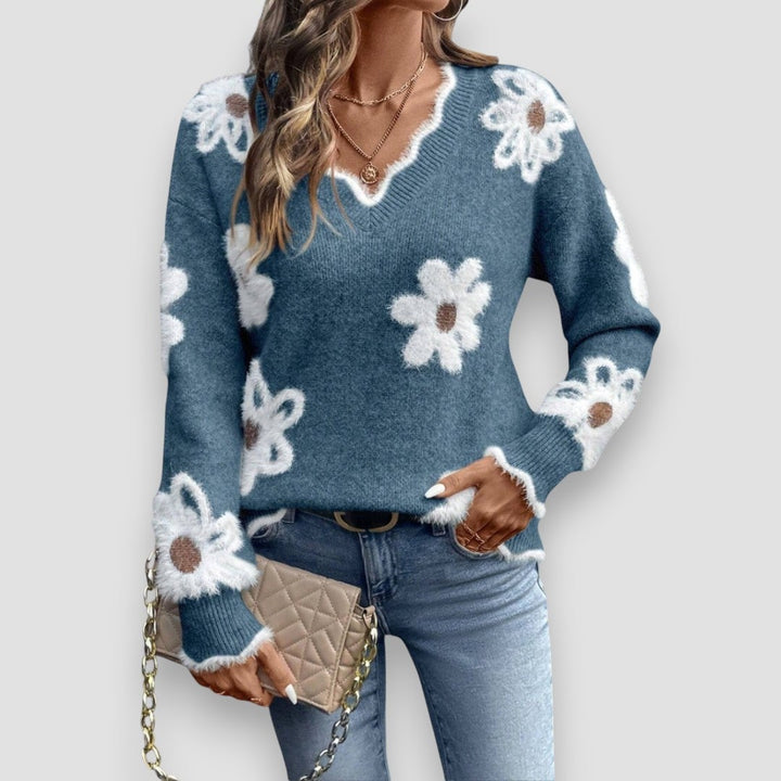 Flat lay of the Madeline sweater in khaki highlighting the soft fabric and floral accents