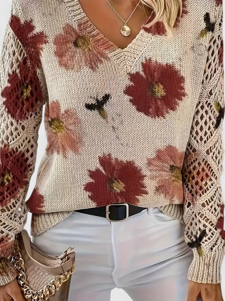 Women's floral sweater in purple styled with high-waisted trousers