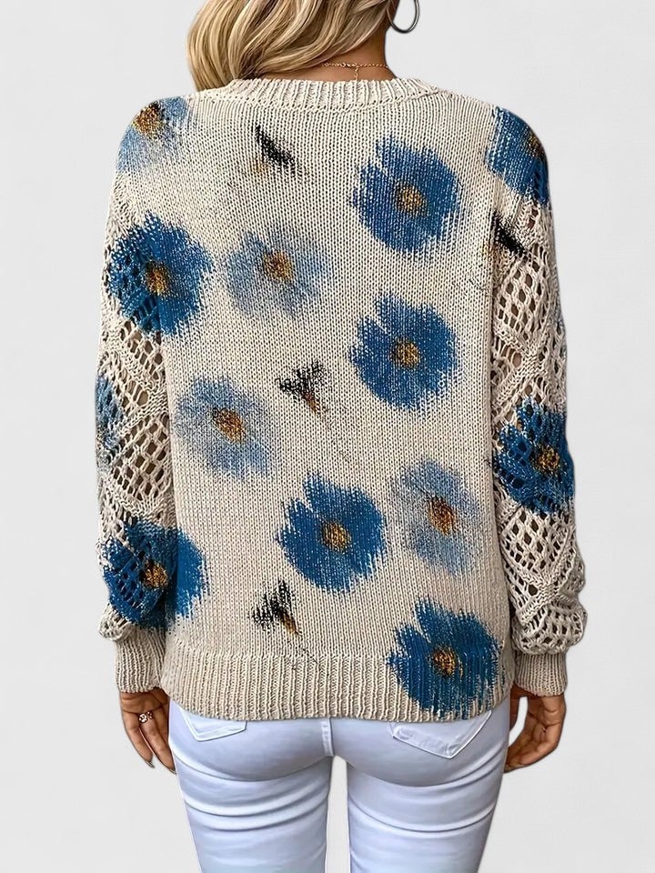 Detail shot of the soft fabric texture on a women's floral pattern sweater