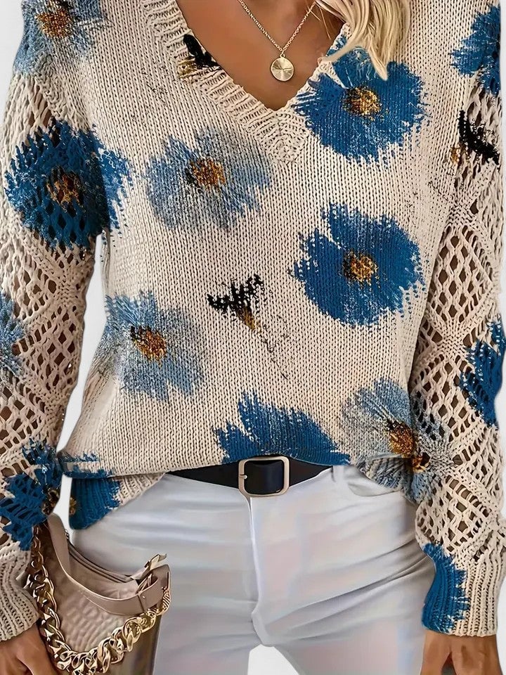 Model wearing a lightweight floral sweater paired with jeans and ankle boots