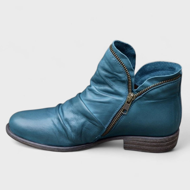 Women's orthopedic boot styled with casual everyday outfit, shown in a neutral setting