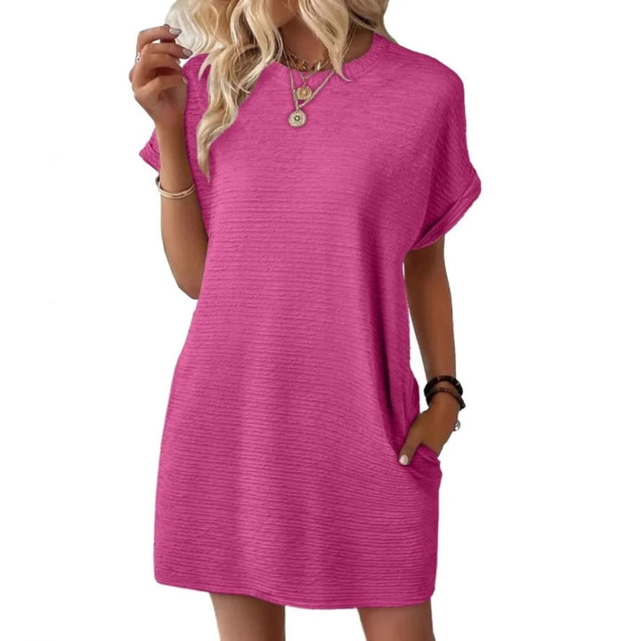 Woman wearing the Maggie short sleeve ribbed mini dress in Rose Red with side pockets