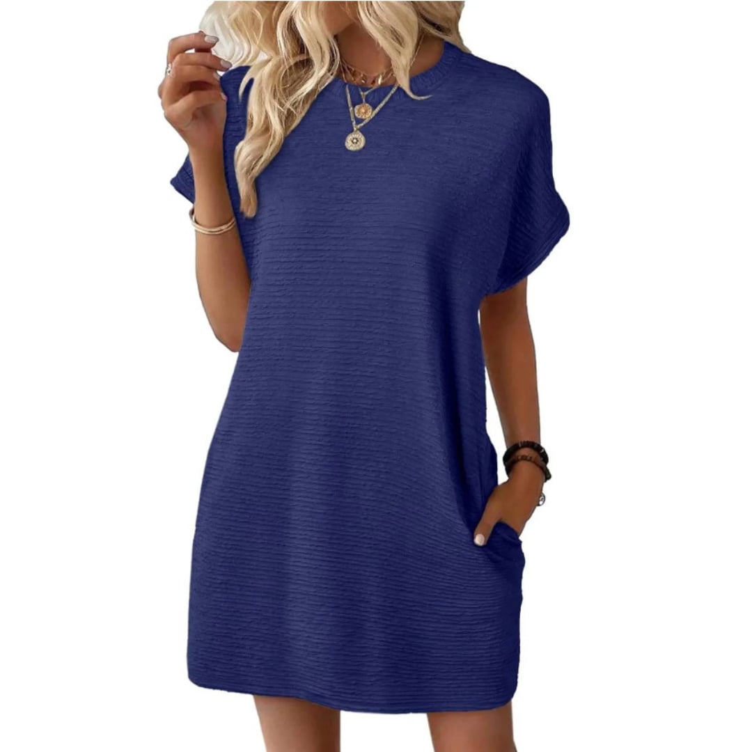 Woman styling the Maggie mini dress in Dark Blue with casual white sneakers
