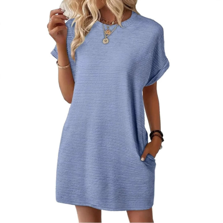 Woman holding the side pocket of the Maggie mini dress in Dark Blue