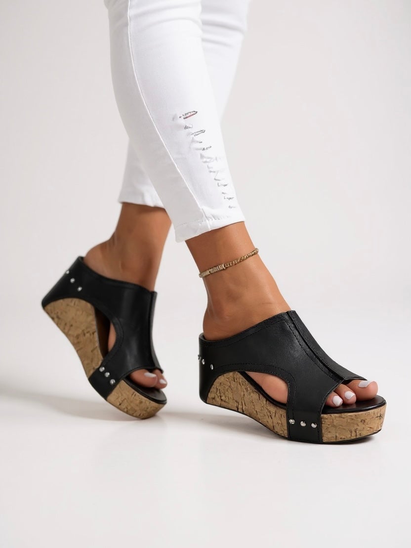 Magnolia cushioned wedge slide sandals in black, side profile view showing wedge sole and minimal strap