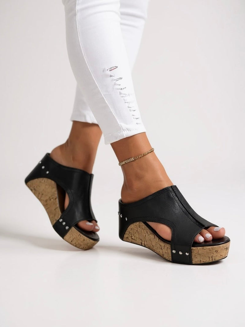 Magnolia cushioned wedge slide sandals in black, side profile view showing wedge sole and minimal strap
