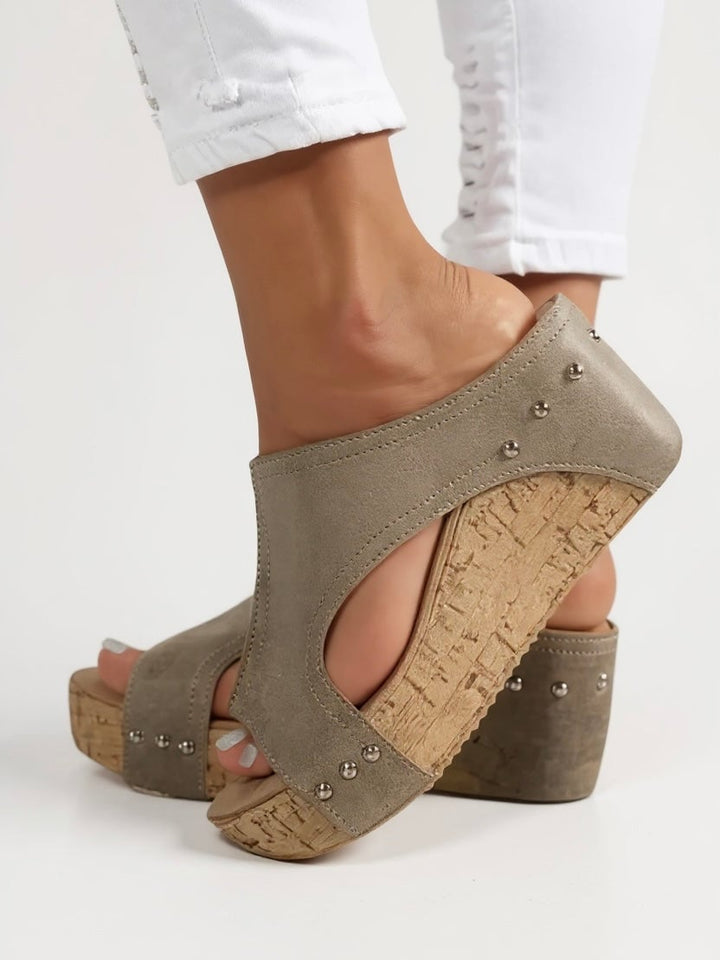 Close-up of Magnolia wedge sandal sole and heel height detail in black