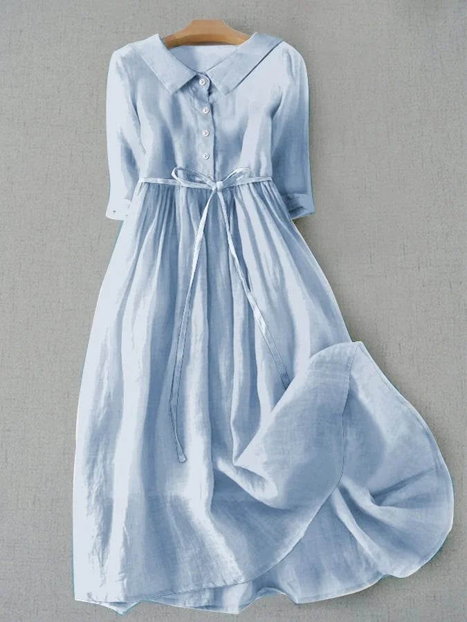 Woman wearing the Magnolia flowy draped midi dress in blue, featuring a soft draped silhouette and feminine midi length