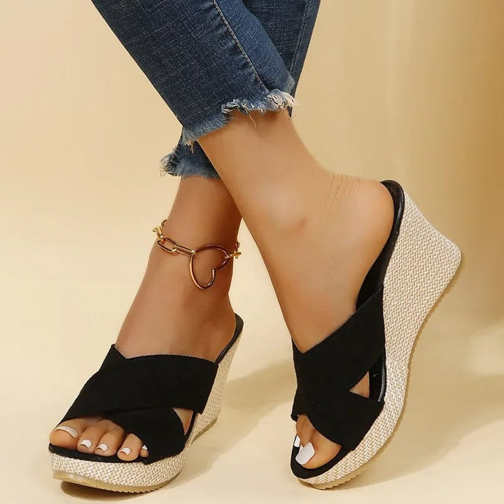 Magnolia women's wedge sandals in black with elegant strap detailing, side view