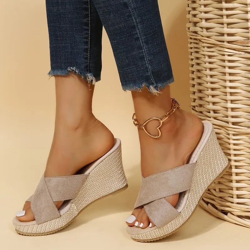 Magnolia women's wedge sandals in black, front three-quarter view showing wedge heel