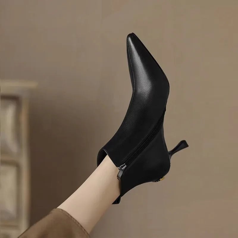 Maja kitten boots in black styled with tailored trousers, side view