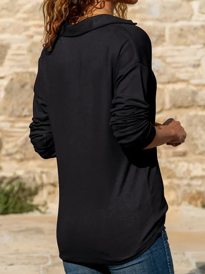 Back view of a woman wearing a ribbed half-zip sweater, emphasizing the clean lines and tailored construction