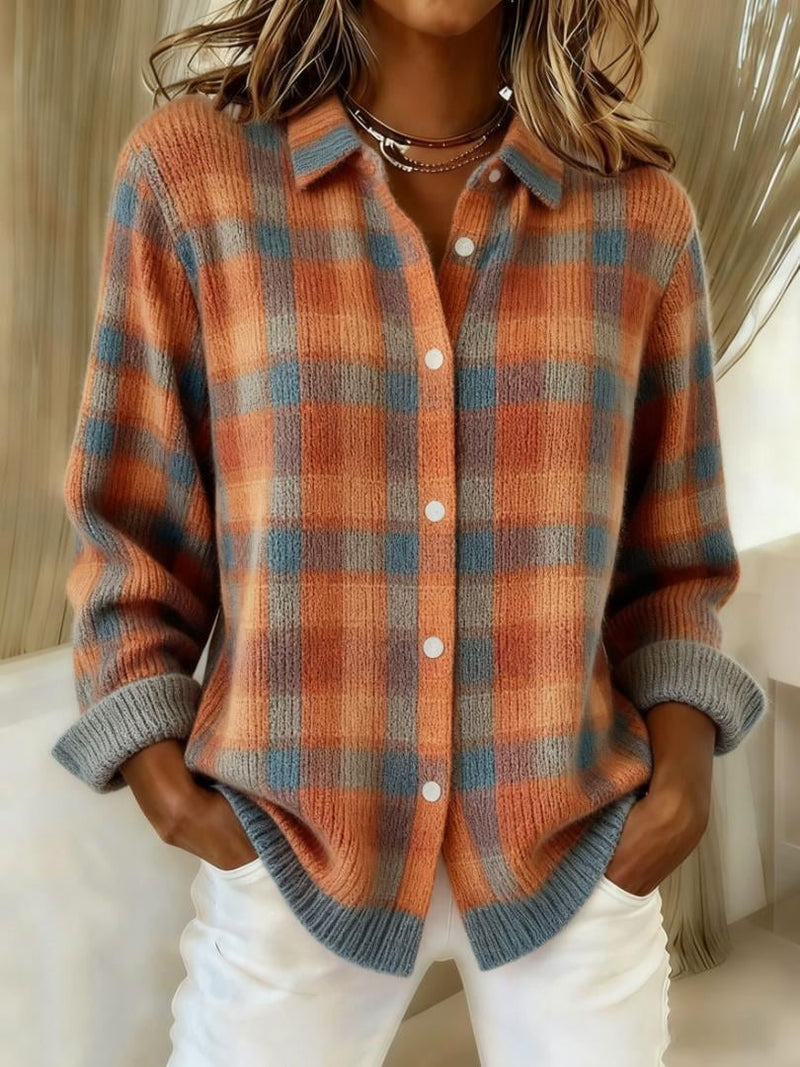 Woman wearing an orange checkered blouse with a gently tailored silhouette, shown from the front