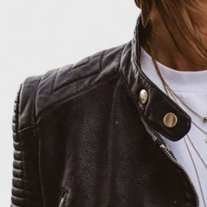 Close-up detail of the elegant black jacket showing fabric texture and structured shoulders