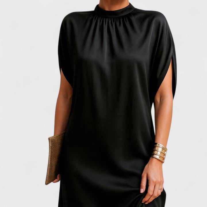 Close-up of the split batwing sleeve detail on a black mock neck mini dress