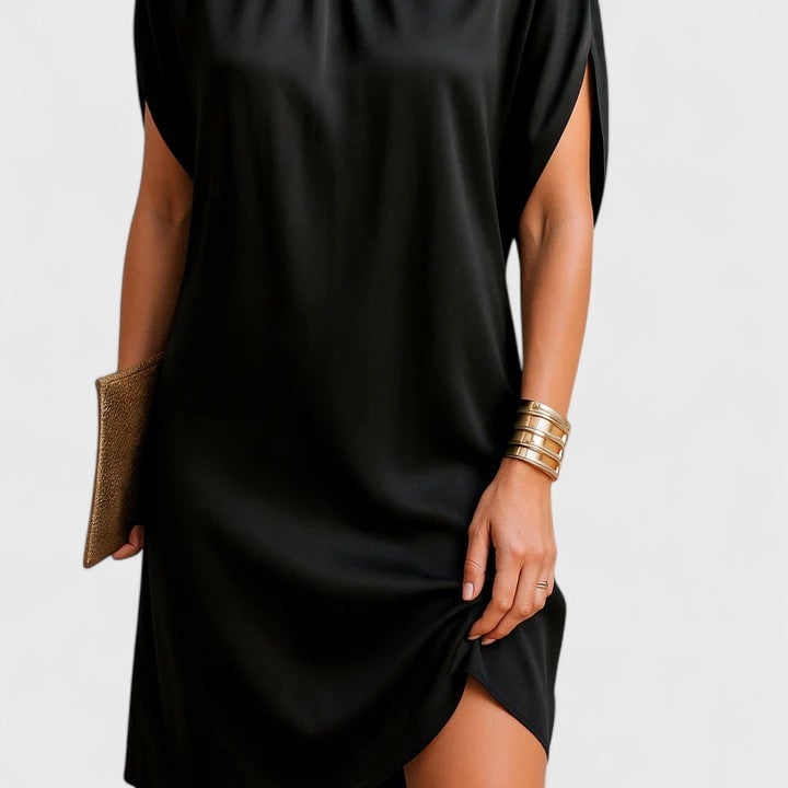 Back view of a black split sleeve mini dress showing clean minimal lines and gathered neckline