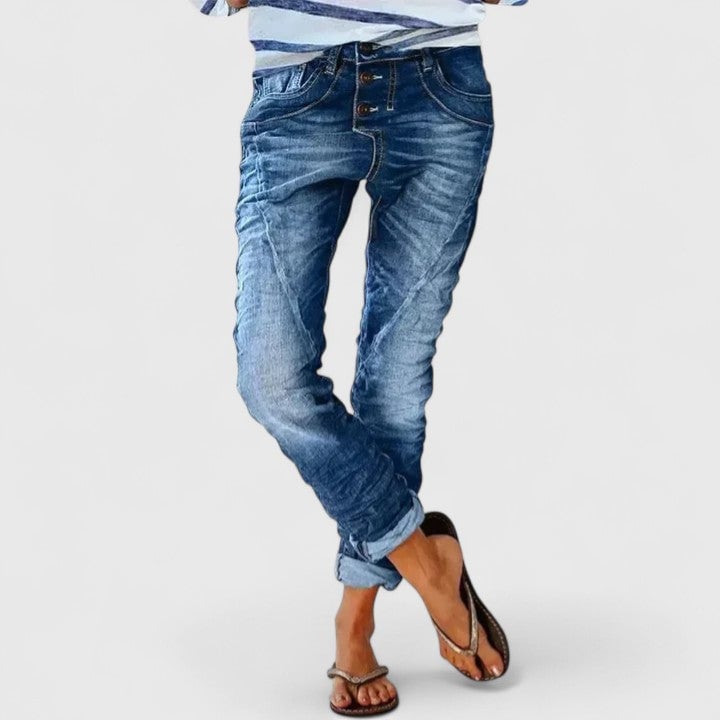 Model wearing Marcella distressed jeans styled with a tucked-in tee and sneakers