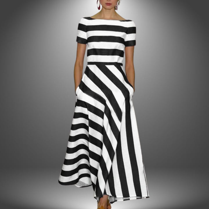 Close-up detail of the handcrafted stripe pattern and flowing fabric of the maxi dress