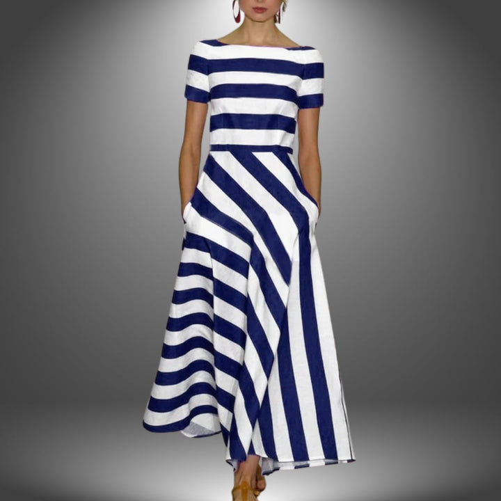 Model styled in the handcrafted striped maxi dress in dark blue showing the flattering drape and fit