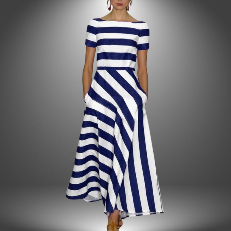 Model styled in the handcrafted striped maxi dress in dark blue showing the flattering drape and fit