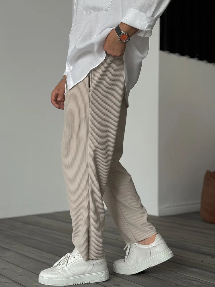 Close-up detail of the tailored waistband and refined finish on the soft everyday trousers