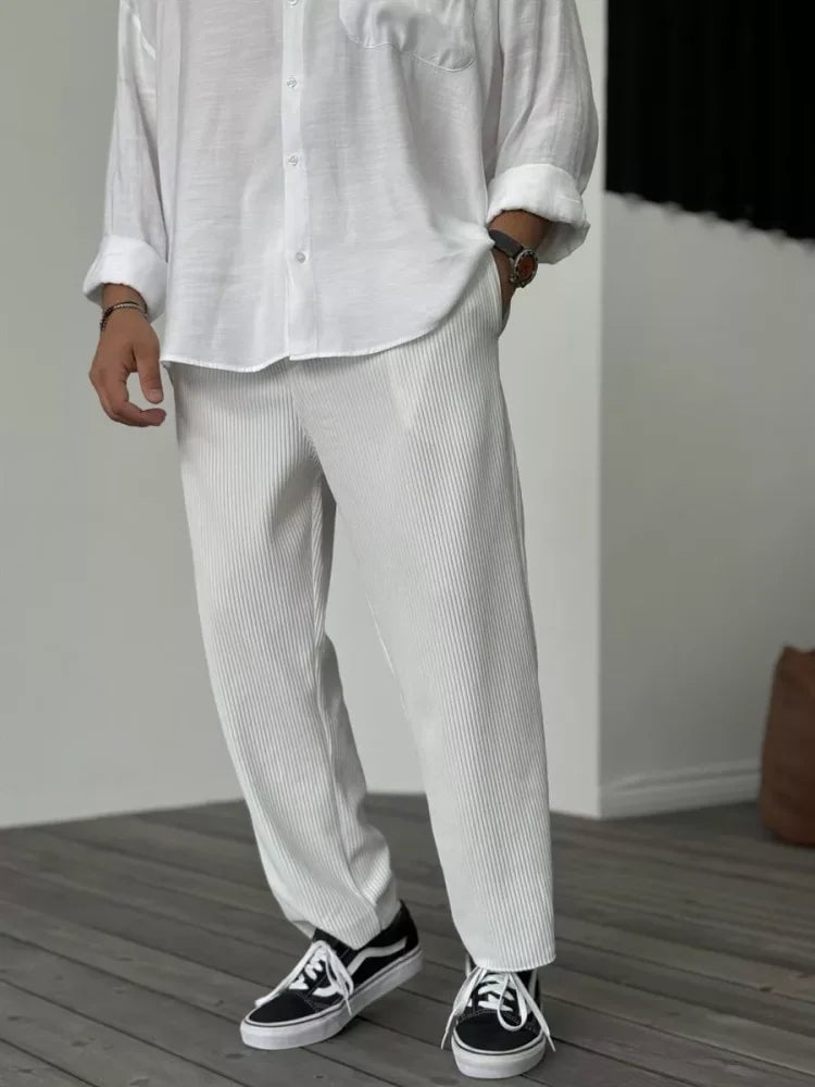 Lifestyle shot of the soft everyday trousers styled with a classic button-down shirt and loafers