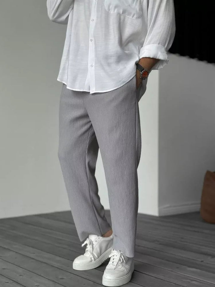 Flat-lay of the everyday trousers in multiple available colors: Beige, Black, Grey, and White