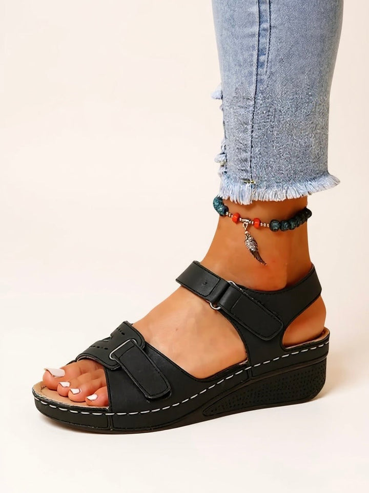 Pair of Maren cushioned wedge sandals in black laid flat on neutral background