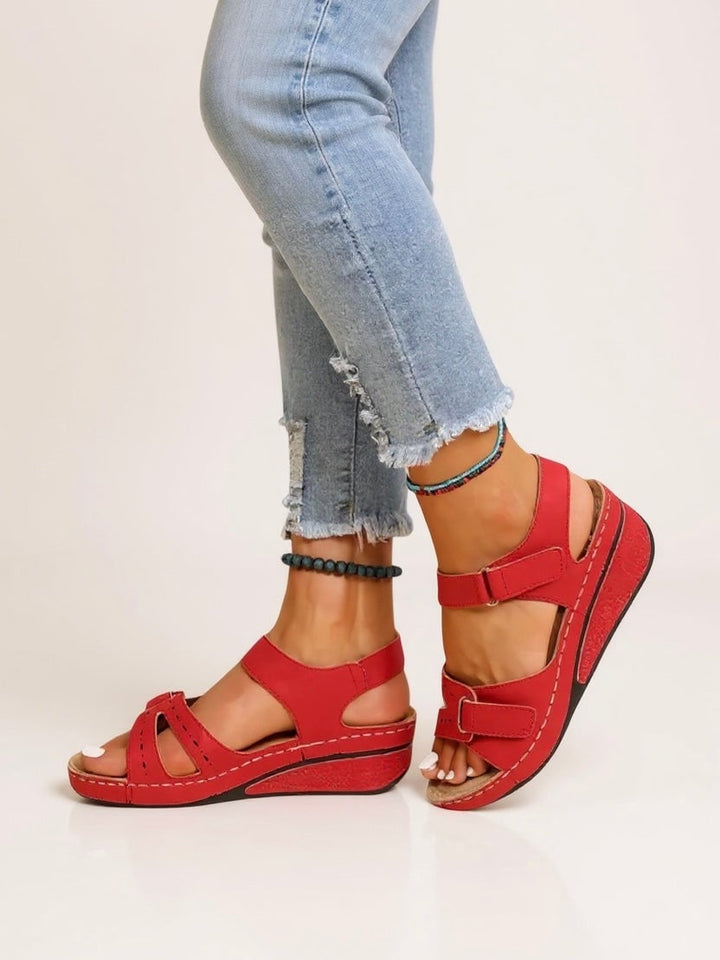 Overhead flat-lay of all four Maren wedge sandal colors: black, red, yellow, and beige