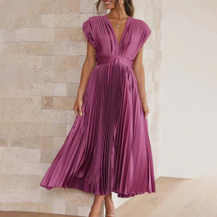 Model wearing the Maren women's wedding guest dress in Champagne, back view
