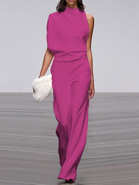 Side view of a black sleeveless wide-leg jumpsuit showing the floor-grazing trouser silhouette
