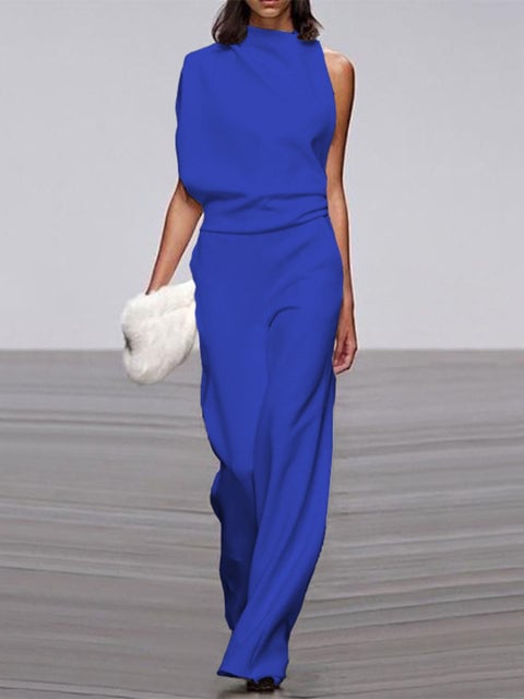 Back view of a woman in a black one-shoulder wide-leg jumpsuit with clean minimalist construction