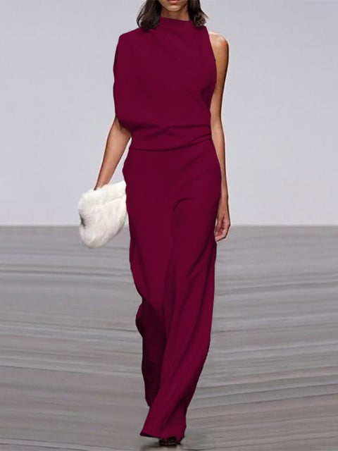 Close-up of the gathered shoulder drape on a pink sleeveless wide-leg jumpsuit