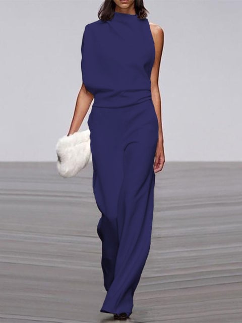 Woman wearing an orange one-shoulder wide-leg formal jumpsuit, full-length front view