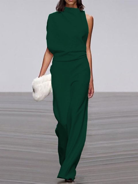 Woman in a red one-shoulder wide-leg jumpsuit with floor-grazing wide-leg trousers