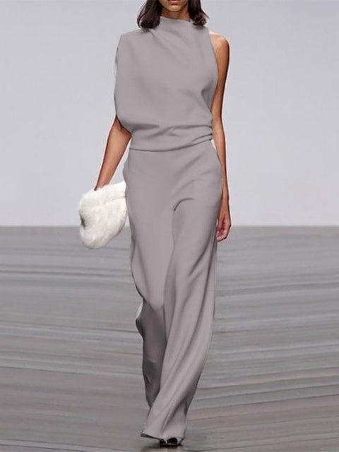 Woman wearing a white one-shoulder wide-leg jumpsuit, elegant full-length front view