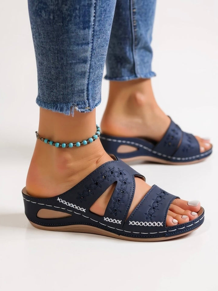 Top-down view of Margaux embroidered sandals in black highlighting stitch pattern