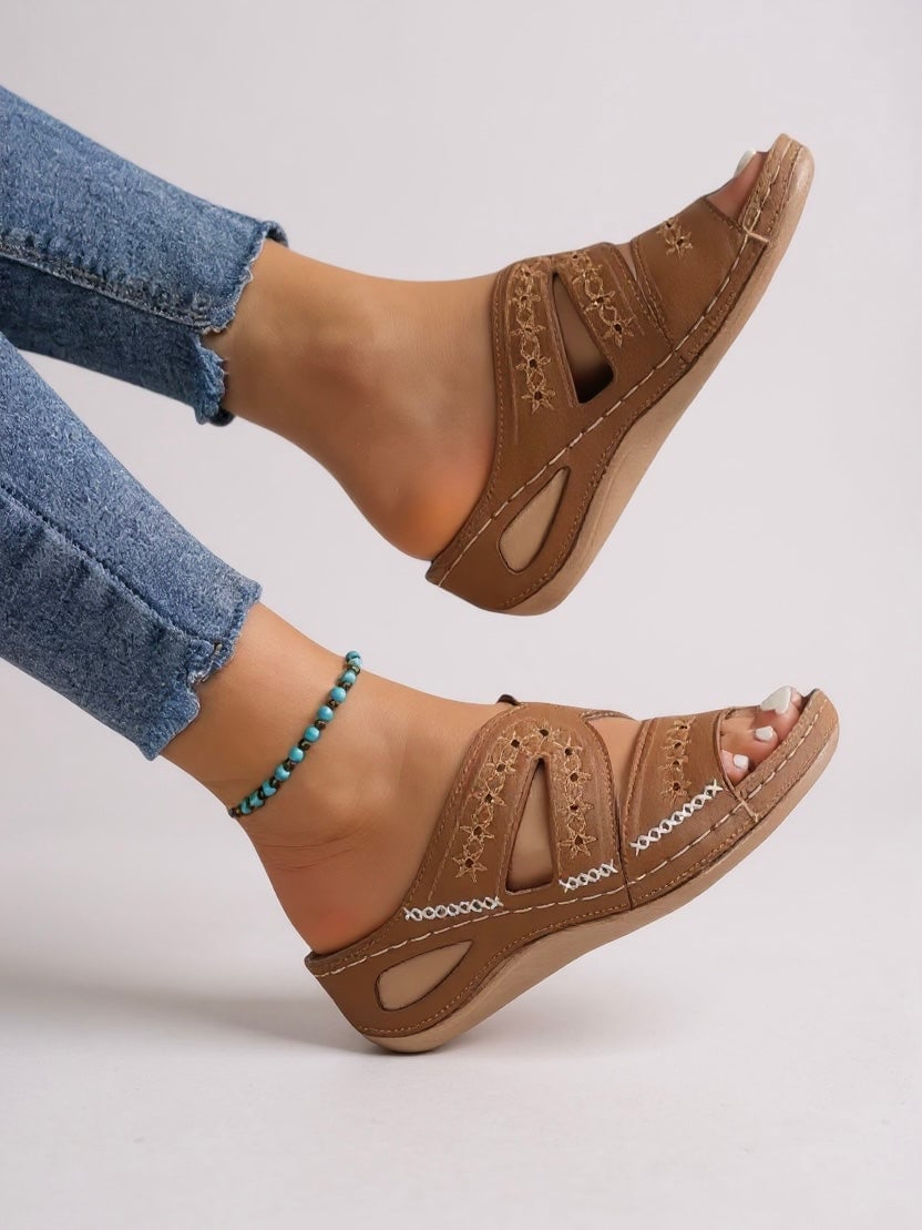 Margaux slide sandals in pink displayed on a light textured surface